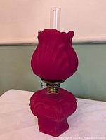 Full view of ruby satin glass miniature oil lamp with chimney