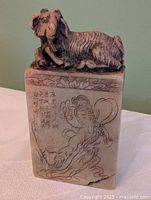 Front view showing ram finial, engraved figure and inscription