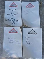 Four autographed sheets with event logo