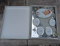 Frame in open box showing inside lid and product