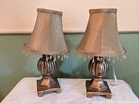 Front view of both matching lamps showing shades, bases and general condition