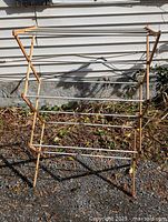 Front view of wooden folding clothes drying rack unfolded