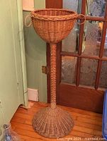 Full view of wicker pedestal plant stand