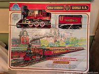 Front view of boxed Walt Disney World R.R. train set showing locomotive, tender and box art