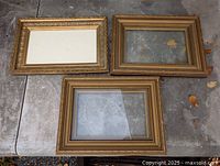 overview of the three vintage gold wooden frames on table