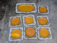 Complete set arranged: 11-in oval tray top, seven square plates below