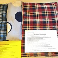 Three grain therapy bags, one large and two small, with instruction sheets