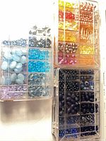 Top view of two storage boxes displaying assorted coloured beads