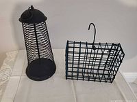 Both metal bird feeders side by side for scale and comparison