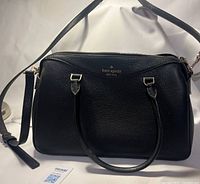 Front view showing Kate Spade logo, handles, and detachable strap