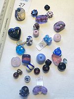 Overview of 31 multi-color handmade glass beads and pendants