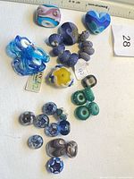 Group view of assorted lampwork beads on fabric background