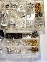 Top view of organizer showing varied silver, gold, bronze findings neatly sorted