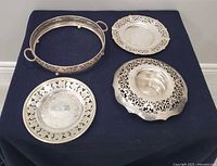 All four silver-plate pieces grouped on dark cloth