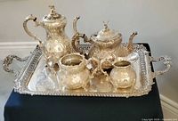 Full view of five-piece silver-plated tea and coffee set arranged on tray