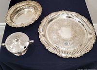 overview of all three silverplate pieces on dark cloth