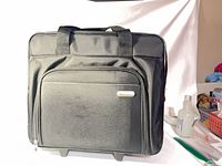 Front view of Targus rolling briefcase showing zip pocket and logo badge