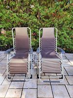 Two zero gravity chairs upright on patio
