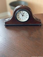 Front view of clock showing overall design and dial