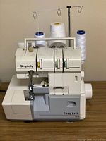 Left-front view of Simplicity serger with four cones attached