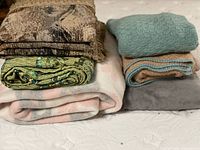 All six folded textiles stacked to show colors and textures