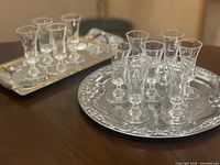 Cordial glasses arranged on both trays