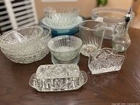 Group shot of entire lot showing variety of clear and blue glass pieces