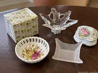 Five decorative pieces displayed together with Precious Moments box visible