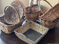 Group view of 11 assorted baskets on table