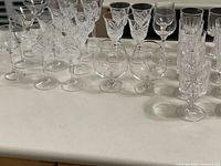 Assorted crystal and glass stemware grouped on countertop