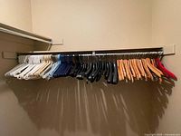 Full rod view showing assorted white, blue, black, wood and specialty hangers