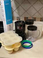 Full lot showing Magic Bullet components, silicone trays, container, comfort rings