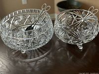 Both cut crystal bowls with tongs shown for scale, showing overall design and size difference