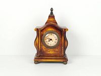 Full view of wooden mantel clock front