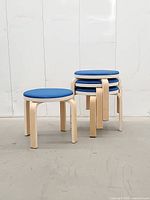 Three stools stacked on one, side angle