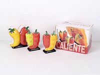 boxed Caliente ceramic napkin holder and two shakers, front view