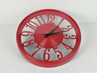 front angled view showing red rim, clear face and numerals