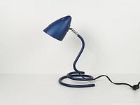 Full view of blue metallic spiral desk lamp with cord