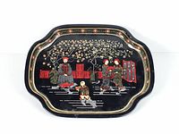 Full view of black metal tray front with Chinoiserie scene and decorative rim
