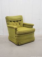 Front angle view showing tufted back, arms, skirted base