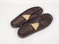 Top view of both slippers showing uppers, insoles with branding and zipper edge