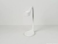 Front angle of white metal curved candle holder