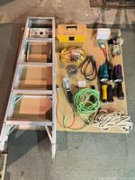 Group shot of entire lot showing ladder, toolbox, cords, tools and accessories