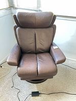 Front view of Stressless chestnut leather recliner showing upholstery and overall design
