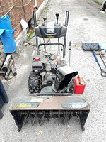 Front view showing auger housing, chute, rust, Yardworks decal