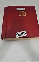 Closed red ABRIA stamp album front cover