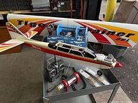 Overall lot with airplane, wing, transmitter, starter, propellers and parts tote