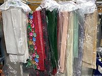 Full set of tablecloths on hangers showing color variety