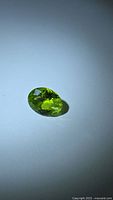 Front view of oval peridot showing color and cut