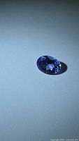 Top view of oval faceted tanzanite showing color and cut